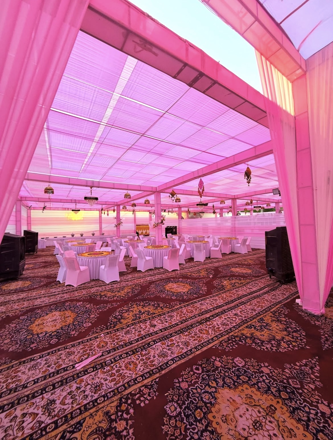 Mahakal pink indoor tent setup with round dining tables