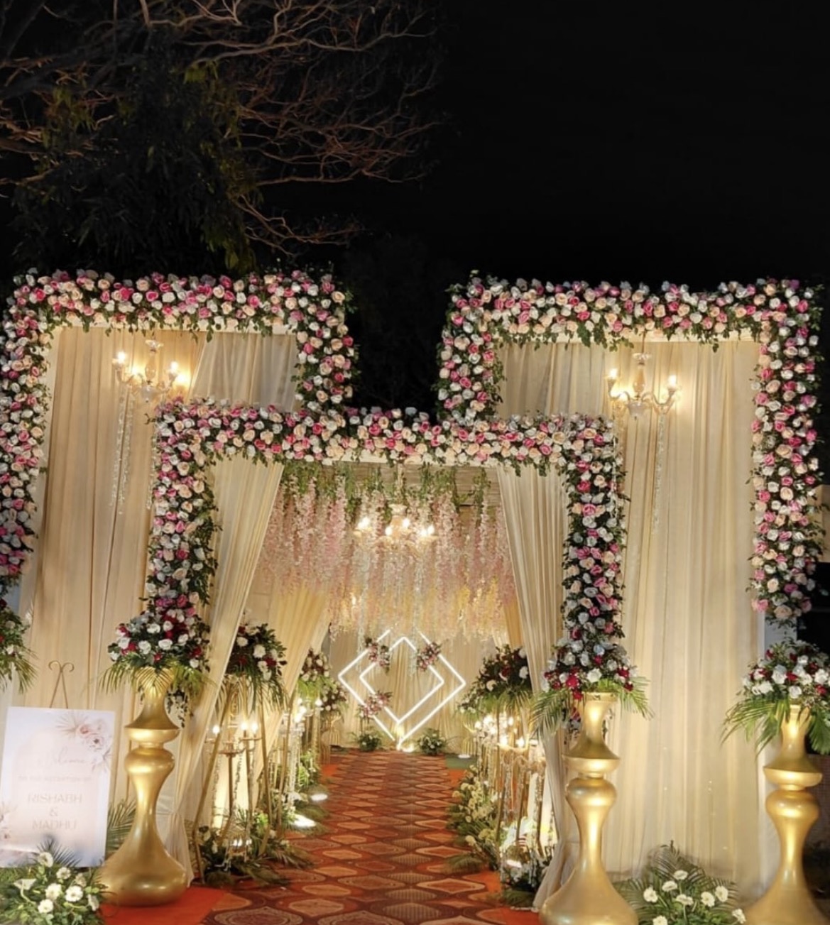 Mahakal floral wedding walkway with chandeliers and warm lighting