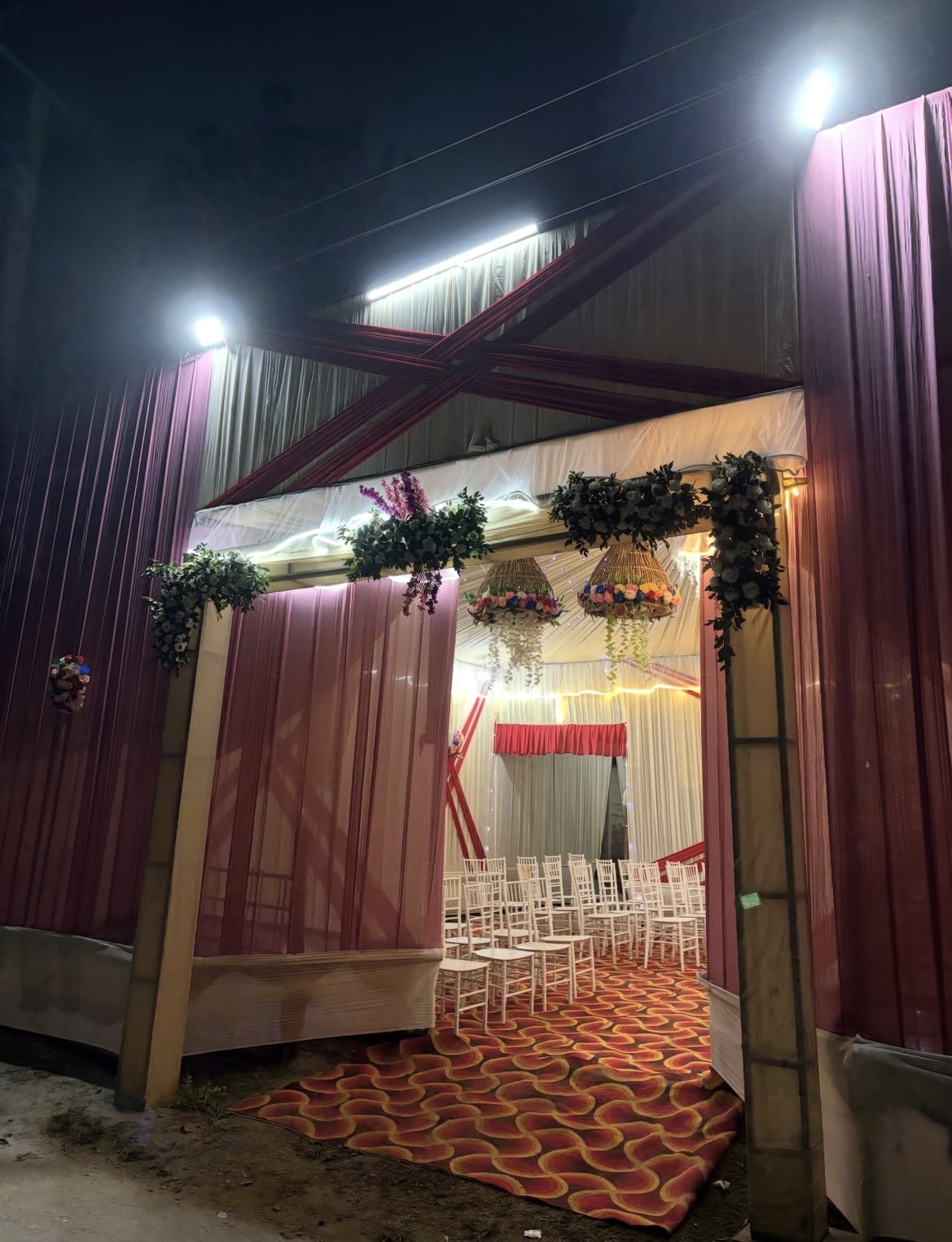 Mahakal decorated tent entrance with floral details and guest seating